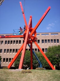 A large red metal sculpture