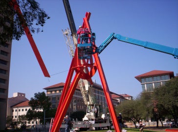 A large red metal sculpture