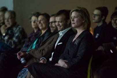 group of people sitting in chairs looking in the same direction