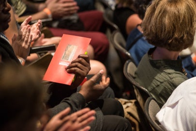 Someone holding an event program
