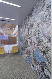 side view of wall with yellow chairs in the background
