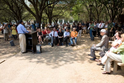 A man talking at a podium in front of an audience