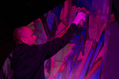 man spray painting