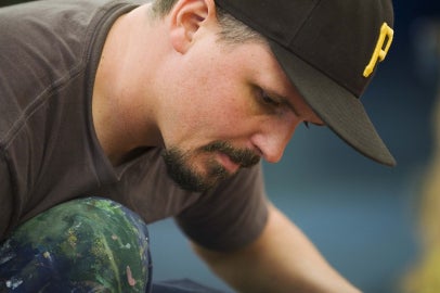 person looking down with hat on