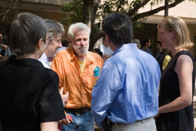 An older man talking to another man