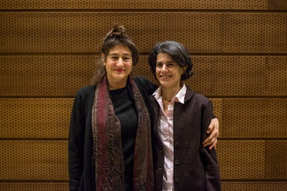 two people standing together facing forward