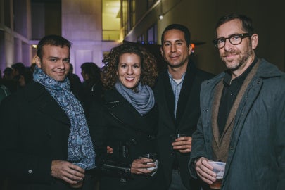 four people standing together facing forward