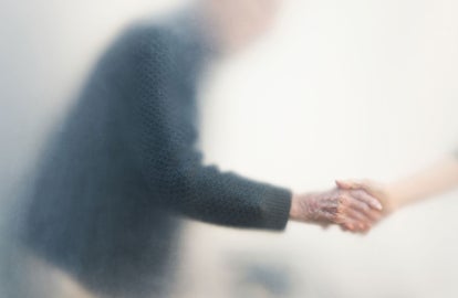 An older gentleman grabbing someone's hand