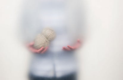 A man holding a ball of twine