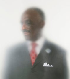A man wearing a suit with a red tie