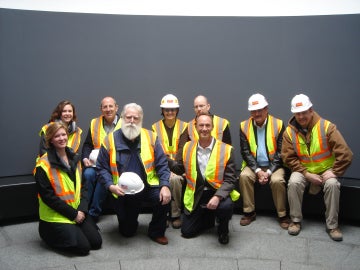 group of people sitting down in a row looking straight ahead