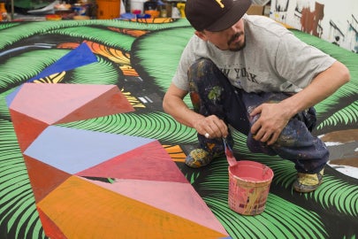 man sitting on multicolored surface