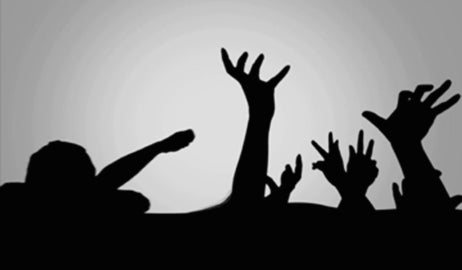 silhouette of hands reaching into sky