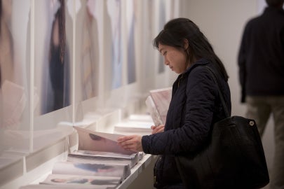 person looking down holding book