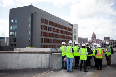 group of people standing toward building