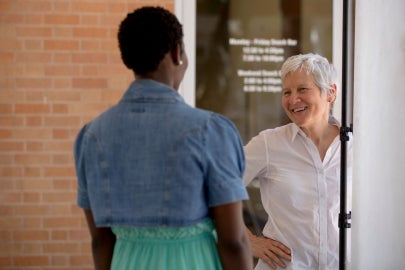 A woman talking to a young woman