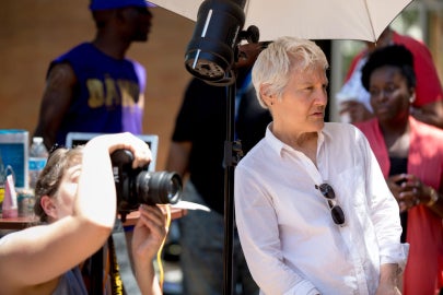 A woman in white and a camera