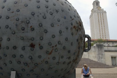 textured sphere with tower in background