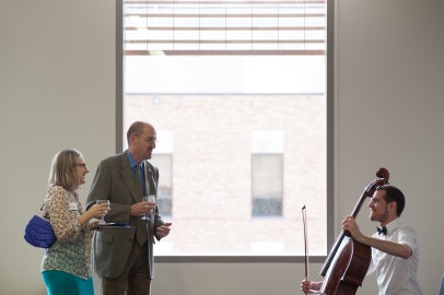 three people in front of window