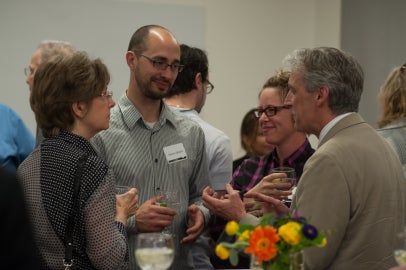 four people standing in circle and talking