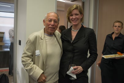 two people standing together smiling