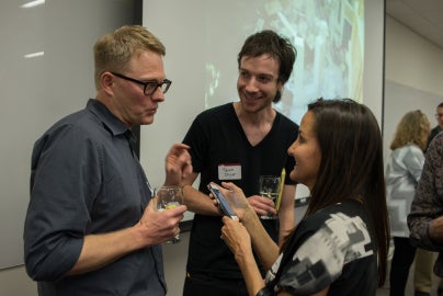 three people looking at each other in conversation
