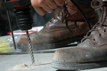 Drill entering surface between two boots