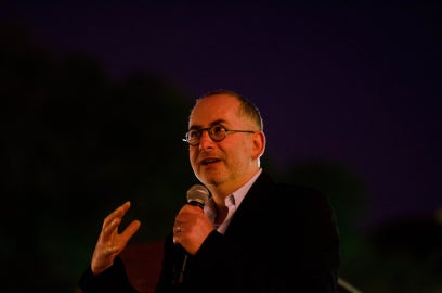 person holding microphone with black background