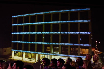 building with projected words blurred across it