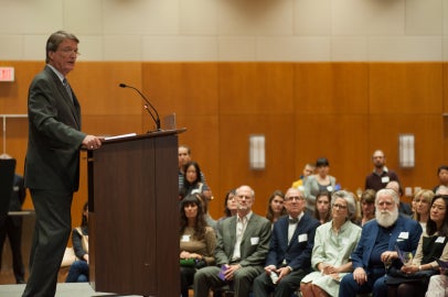 person standing on stage facing audience
