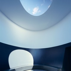 Lighting shining through an oculus into a cylindrical room