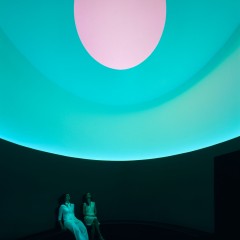 Two figures inside a cylindrical room with an oculus overhead