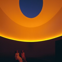 two people sitting in orange lit room