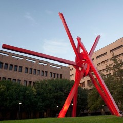 A large red metal sculpture