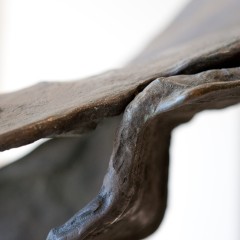 Detail of a winged sculpture on a base