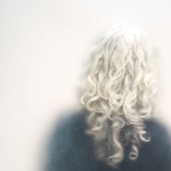 A woman with curly silver hair