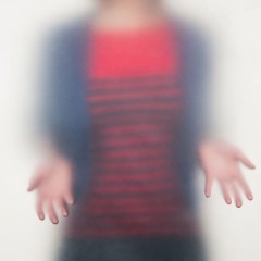 A person with a red striped shirt holding their hands out