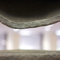 A metal half circle with a flat metal bottom