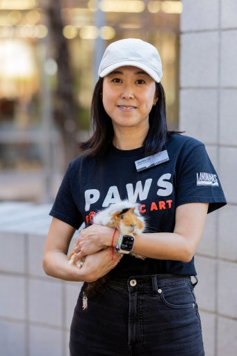 a woman holds a guinea pig