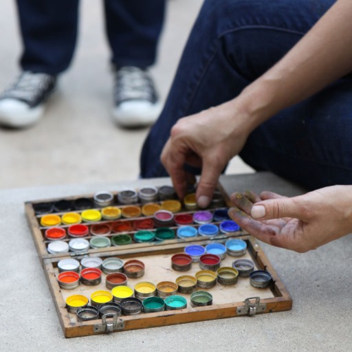 A selection of paints in a small wooden box