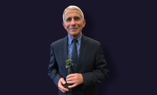 Image is of Dr. Anthony Fauci holding a miniature replica of Landmarks collection artist, Seymour Lipton's "Pioneer." Dr. Fauci stands in front of a plain navy background