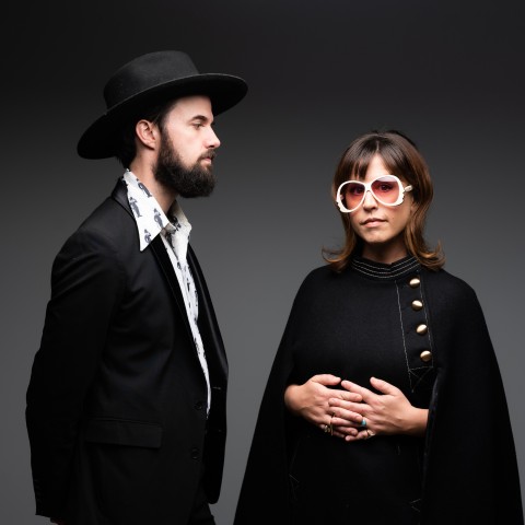 A band photo of a man and woman.