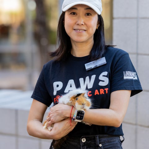 a woman holds a guinea pig