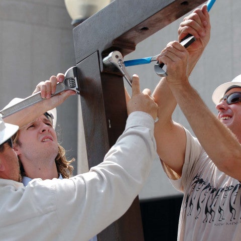 Three men install Joel Perlman's "Square Tilt"
