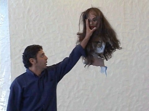 Teresa Serrano, La Piñata, 2003 A man grabbing the face of a piñata resembling the top half of a woman