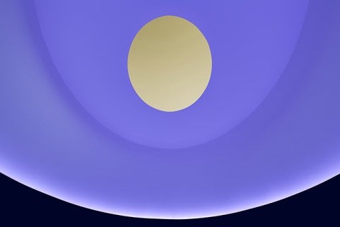 Purple walls with an oculus revealing a yellow sky in the James Turell Skyspace