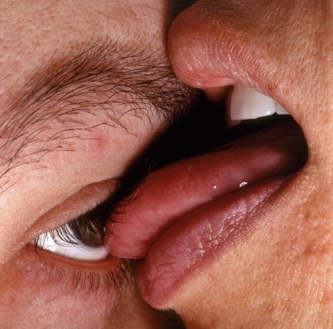 An artwork by Janine Antoni in which a person licks an eye.