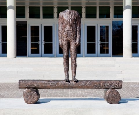 photo by Ben Aqua Headless statue in front of a large building