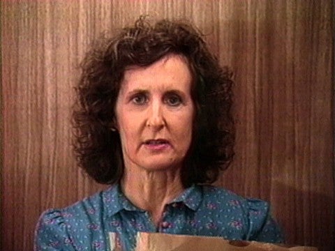 Burt Barr, The Elevator, 1985 A woman with curly hair and a blue dress