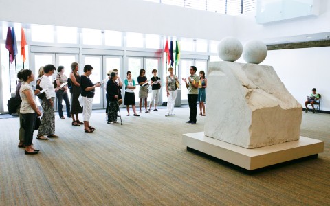A docent tour surrounding Louise Bourgeois' sculpture "Eyes"